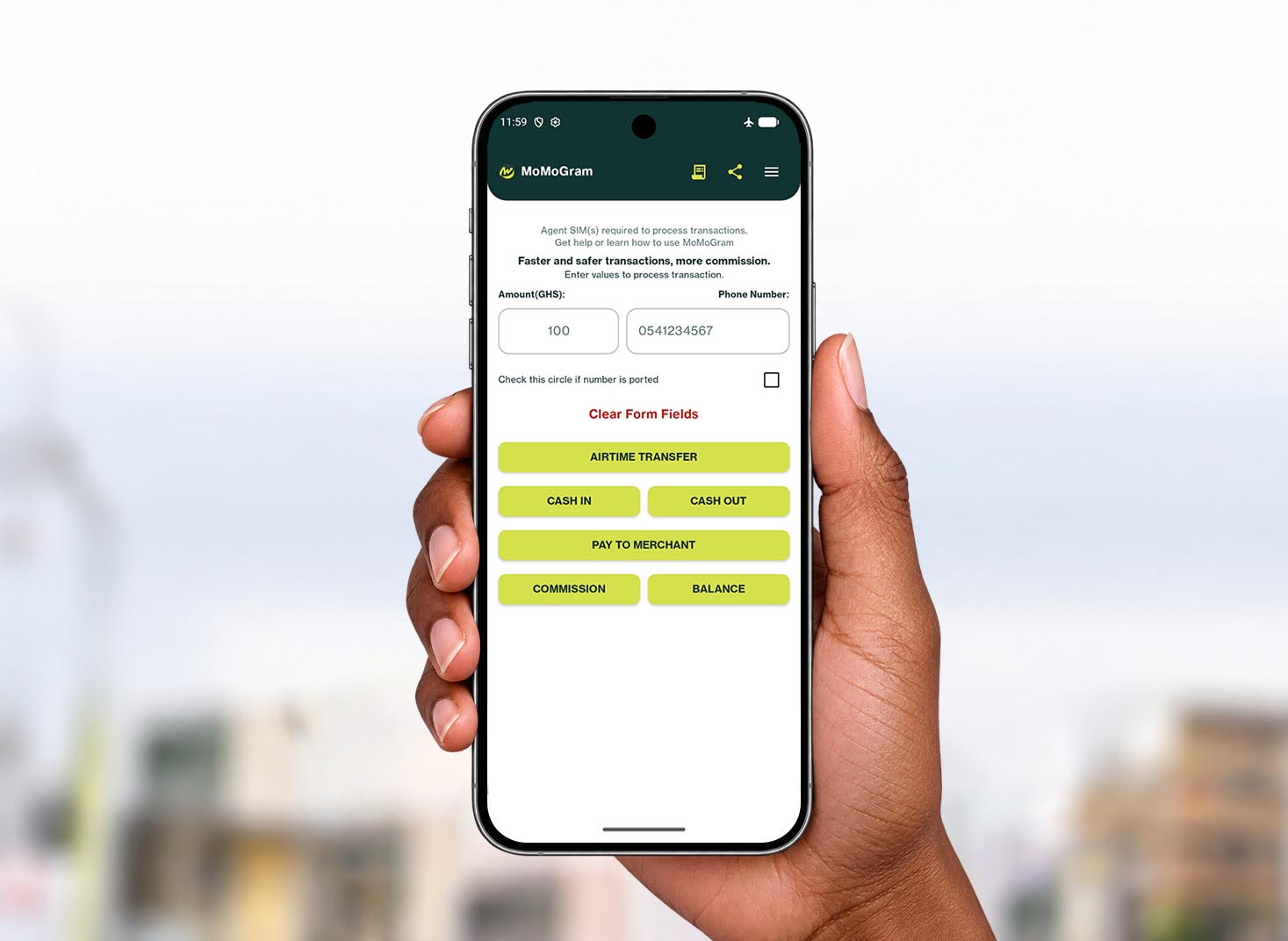A hand holding a phone showing the MoMoGram dashboard